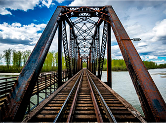 Image of train tracks on a bridge.